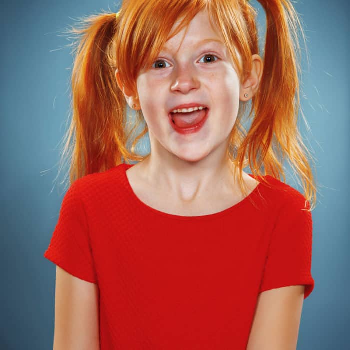 beautiful portrait of a happy little girl smiling PGUQTNN 700x700 1